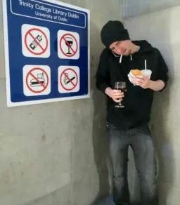 man using things near a sign