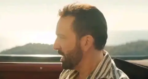 Nicolas Cage and Pedro Pascal laughing in car