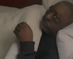 A strange look of the man in the bed