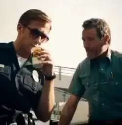 Man talking with Ryan Gosling as a cop