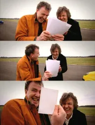 Two men looking at paper and laughing