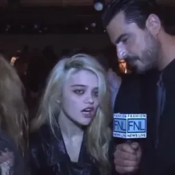 The man is interviewing and poker face girl
