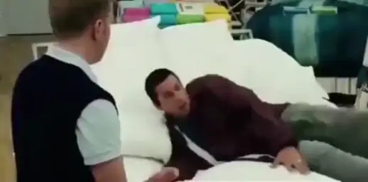 Man waking up in the store on the bed