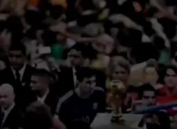Messi looking at the World Cup Cup in the midst of the crowd