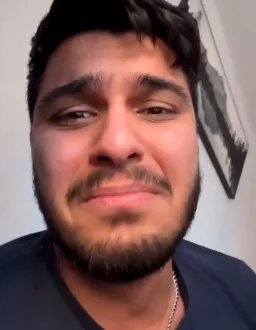 The boy is laughing out loud