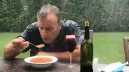 مرد درحال غذا خوردن زیر باران شدید