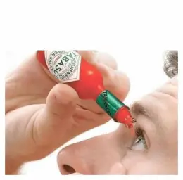 Tabasco hot sauce drop into eye