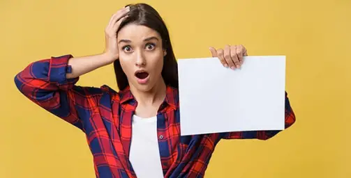 Surprised woman with paper in hand