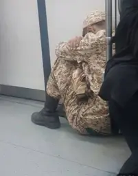 sad soldier in metro