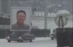 showing north korea leader photo with car