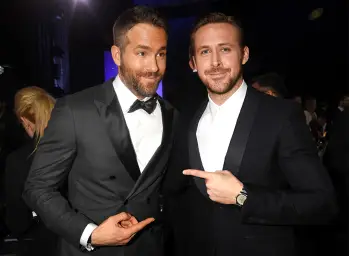 Ryan Reynolds and Ryan Gosling pointing at each other