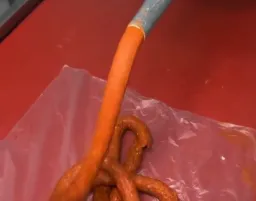Orange dough coming out from tube