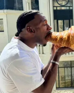 Man eating something bigger than his mouth