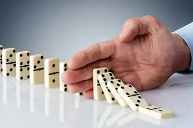 Hand Stopping Dominoes