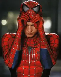 Spiderman putting on mask