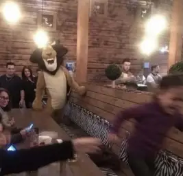 Kid running from Alex the Lion