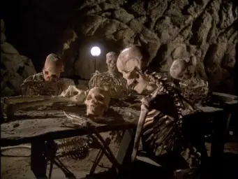 Skeletons waiting around a table