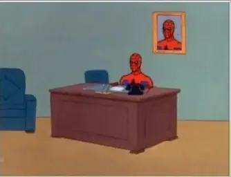 Spiderman sat at desk