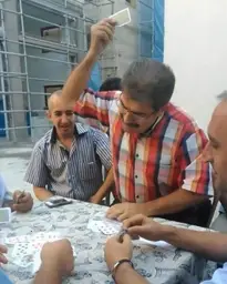 Man Smacking Cards Down On Table